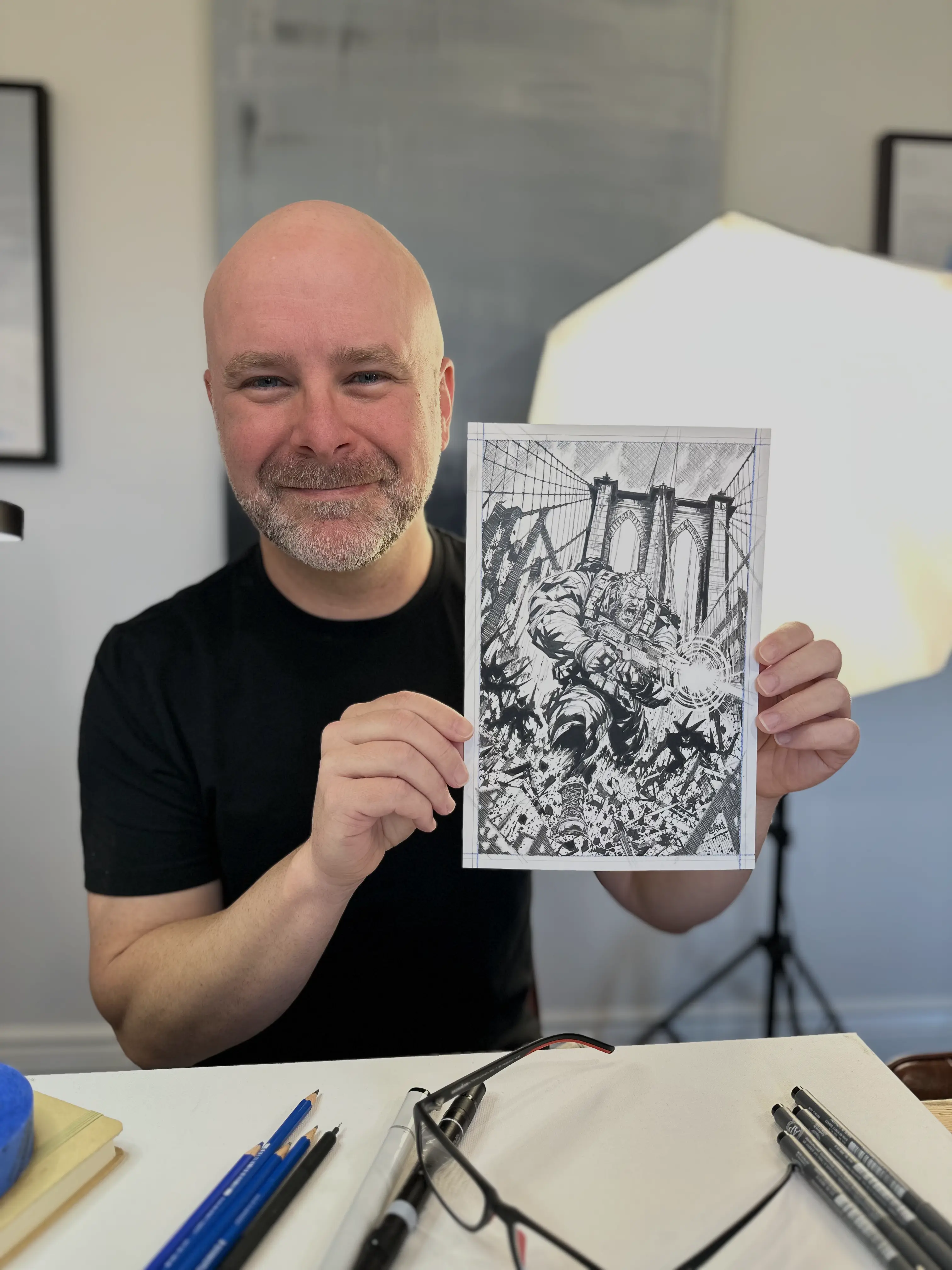 Christopher holding his original ink drawing of The Battle of Brooklyn Bridge